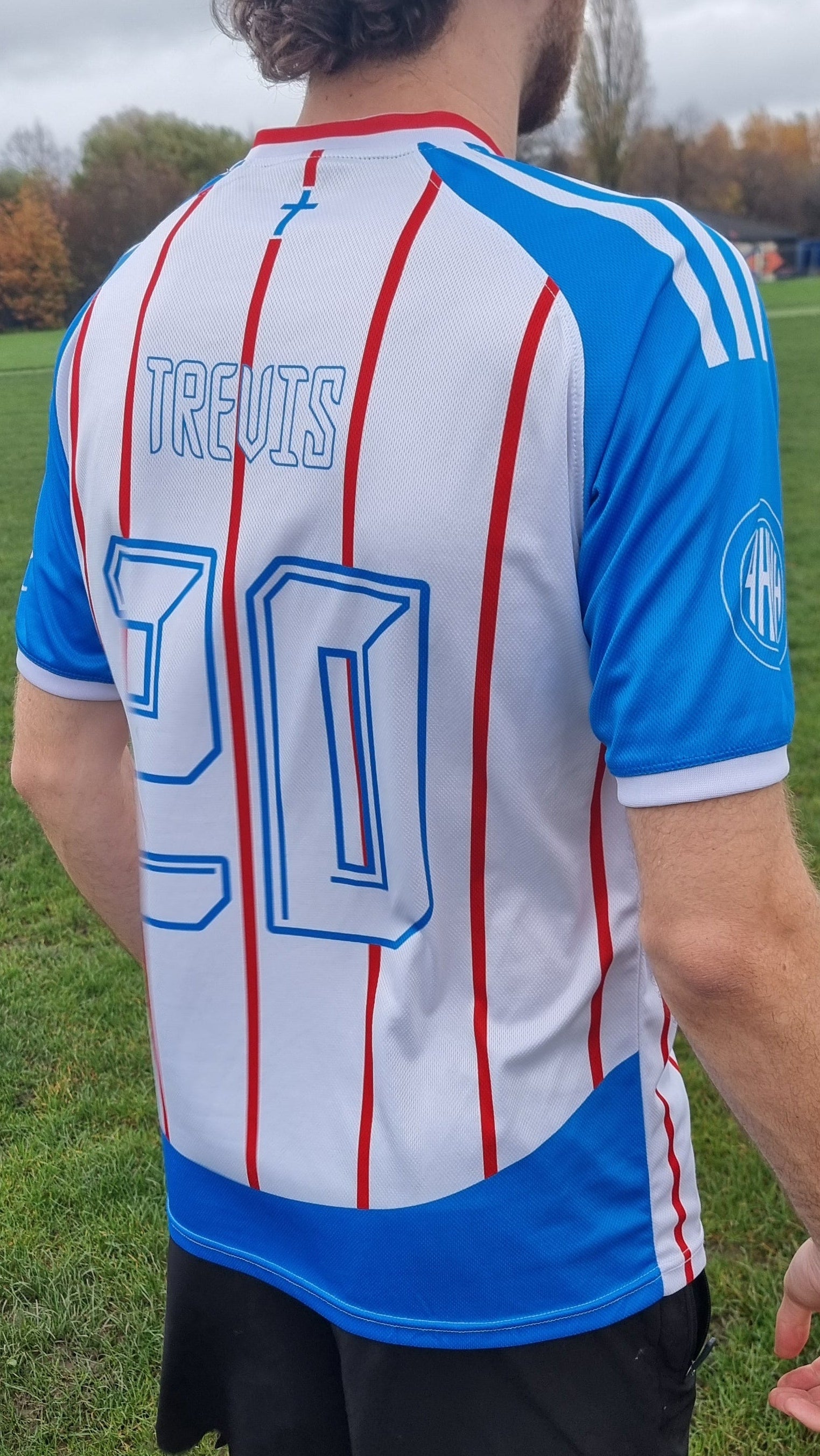 Person wearing a sports jersey with a number on a grassy field